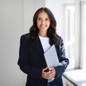mature-woman-entrepreneur-holding-laptop-posing-b-2025-03-18-18-03-37-utc
